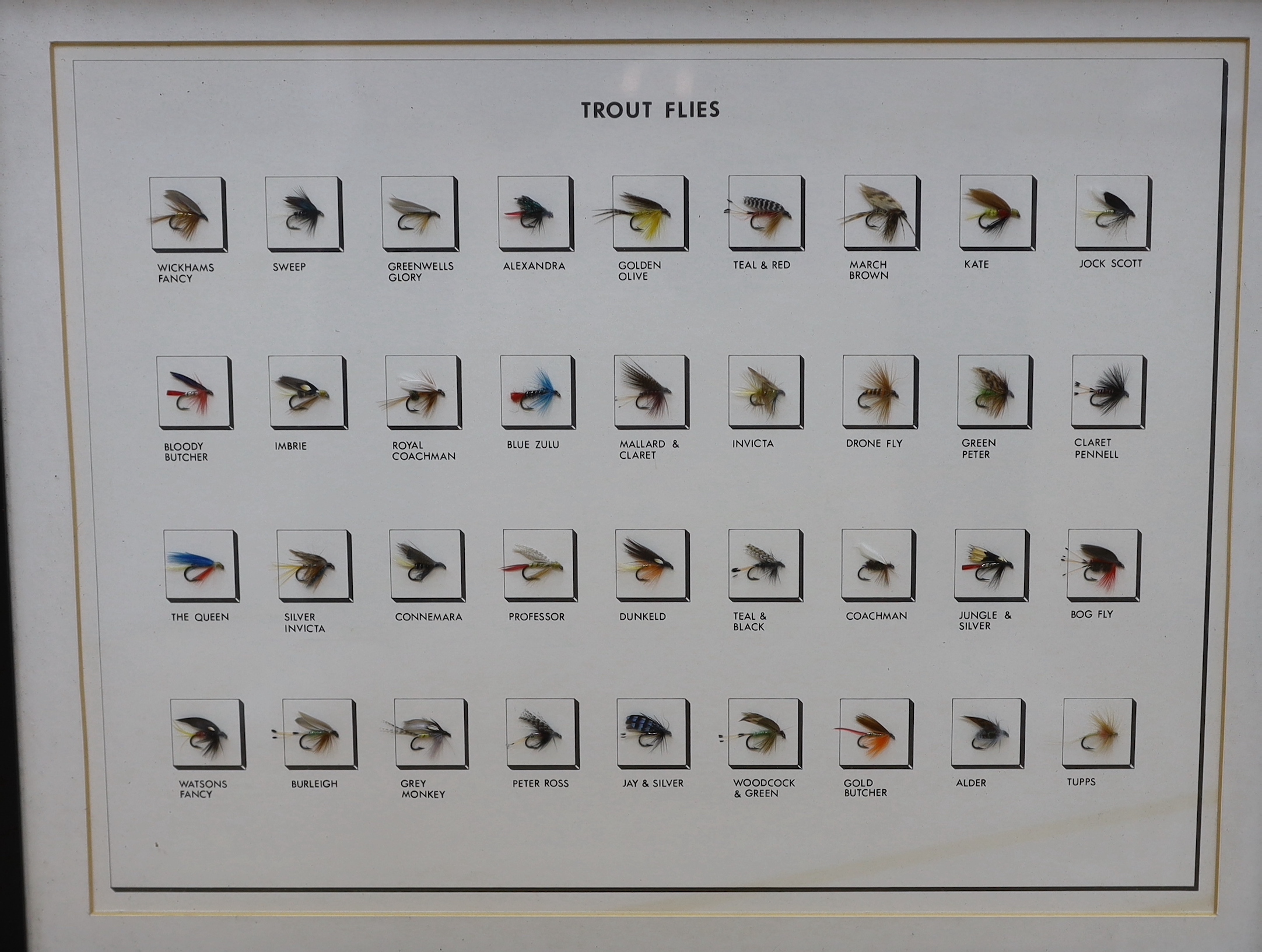 A collection of three framed and glazed fishing flies